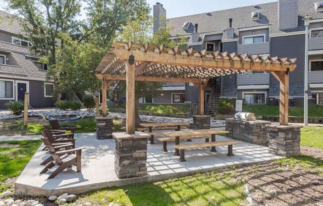 an outdoor patio with a picnic table and a pergola