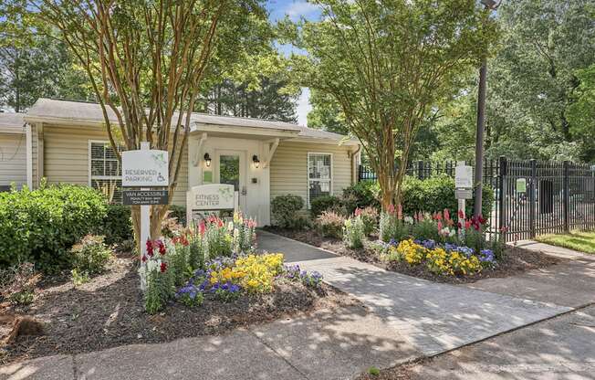 a house with a sidewalk and flowers in front of it