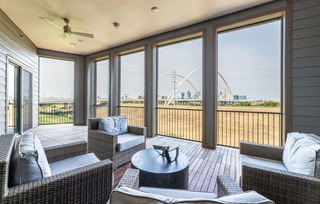 a screened in porch with a view of a ferris wheel