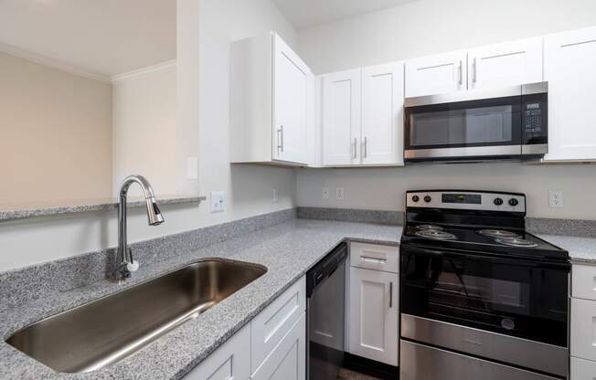 Kitchen featuring black appliances and granite counters at Center Point Apartments, Indianapolis