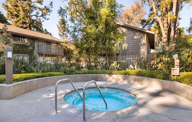 An outdoor spa in a garden.