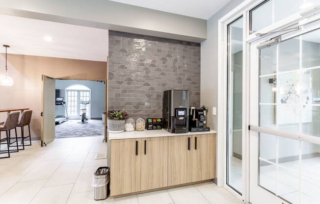 a kitchen with a coffee machine and a microwave on a counter