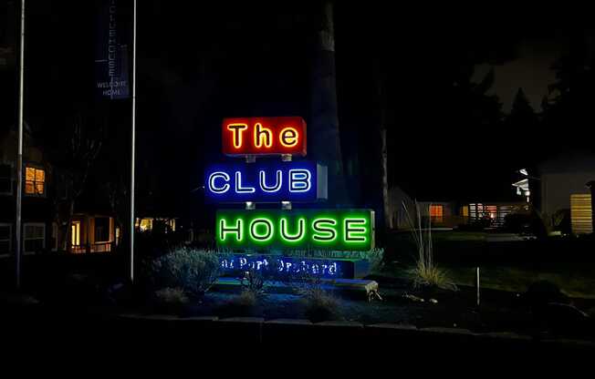 The Club House is lit up at night.