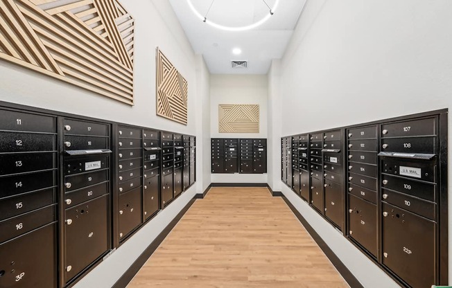 A long hallway with black mailboxes on either side.