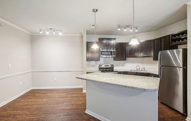 a kitchen with stainless steel appliances and a granite counter top