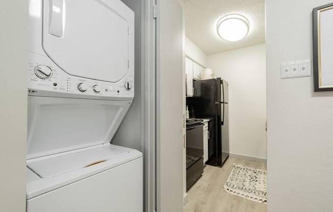 a laundry room with a washer and dryer and a kitchen