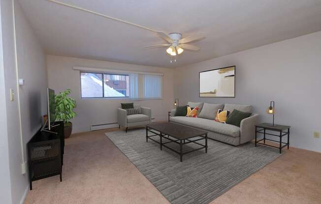 a living room with a couch and a coffee table. Fargo, ND North Manor Apartments