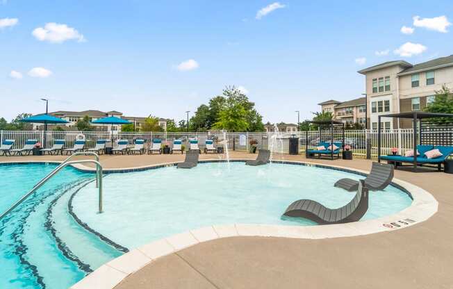 resort style pool with lounge chairs on in-water ledge