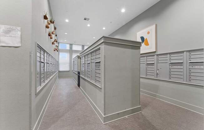 A long hallway with a white wall and a poster on it.