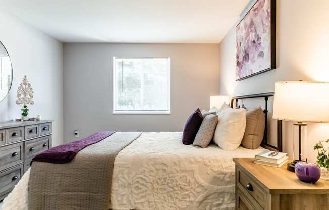 a bedroom with a bed and dresser