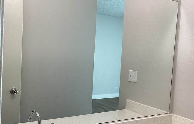 A bathroom with a sink and mirror.