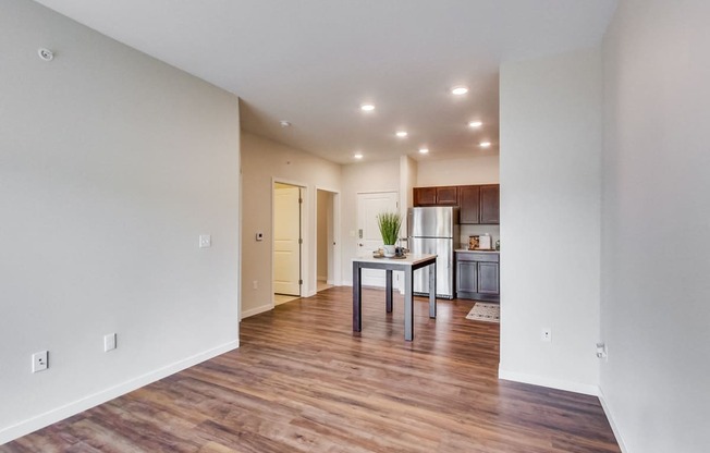 a spacious living room with a kitchen