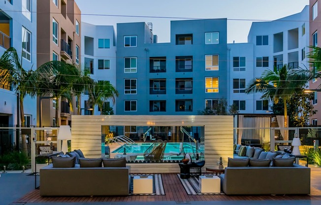A modern building with a pool in the courtyard.
