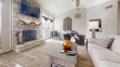 a living room with a couch coffee table and a fireplace