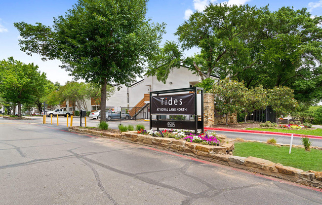 the sign at the entrance of tides on the street