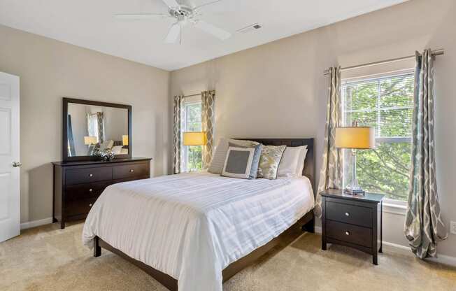 a bedroom with a bed and a ceiling fan