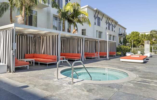 multiple outdoor covered cabanas next to jacuzzi