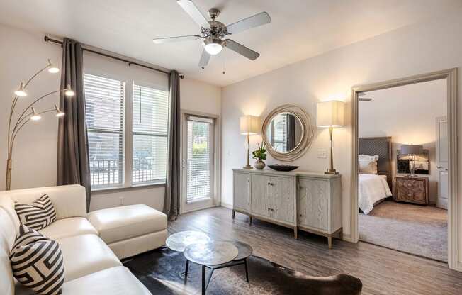 a living room with a couch and a ceiling fan