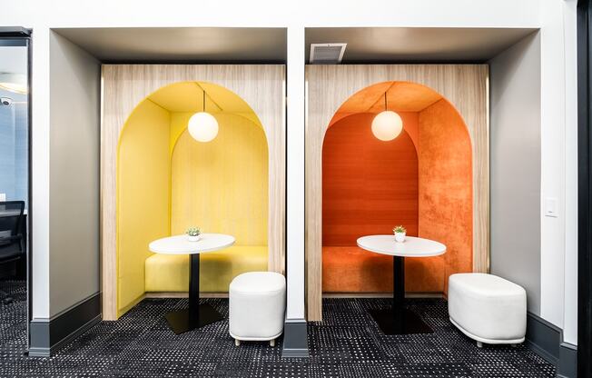 a meeting room with two tables and a yellow and orange wall