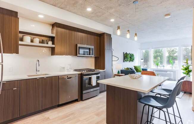 A modern kitchen with dark wood cabinets and a white countertop.