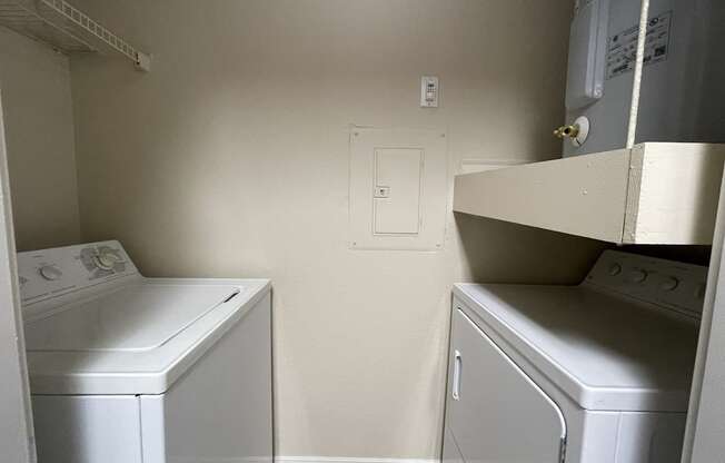 A small laundry room with a washer and dryer.