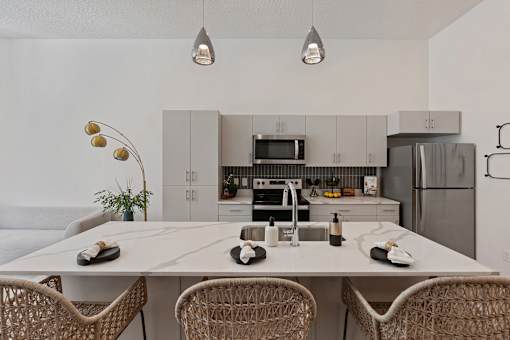 an open kitchen with a large island with a white counter top at SevenO2 Main Apartments, Salt Lake City