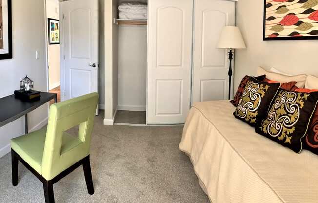 guest bedroom in 2 bedroom model with twin size bed,
standard size closet,
small desk with chair