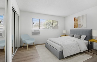 a bedroom with a bed and a chair and a sliding glass door