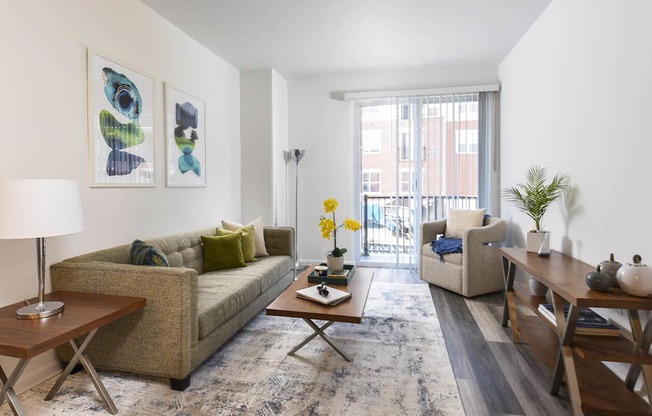 a living room with a couch and a table and a window