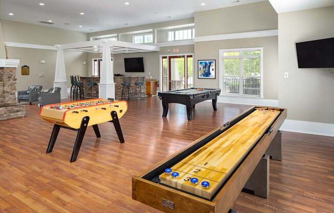 A pool table with a wooden top and a set of balls arranged in a triangle at one end.