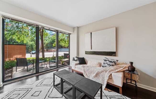 A living room with a couch, coffee table, and sliding glass doors.