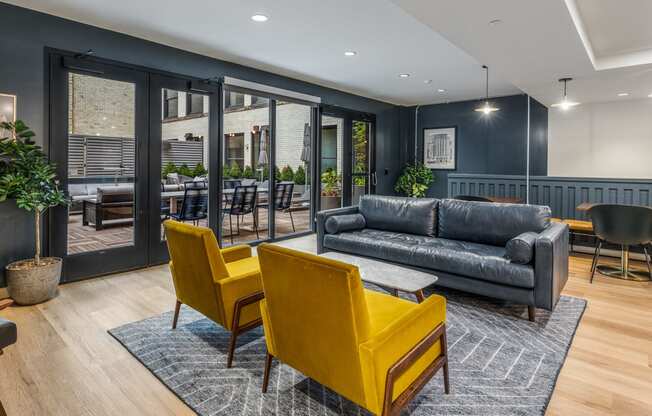 a living room with blue walls and yellow chairs and a couch at The Commonwealth Building, Pittsburgh, Pennsylvania