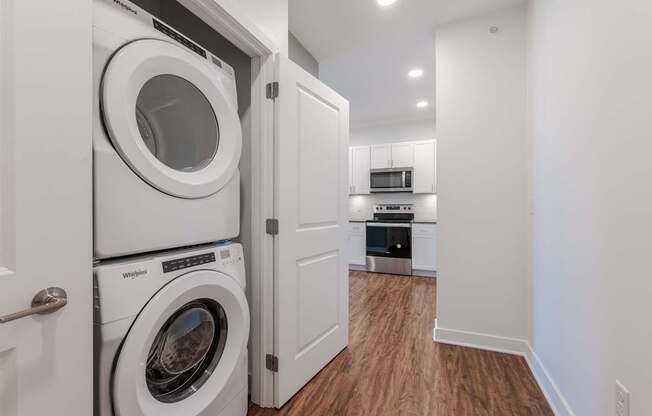A white washing machine and dryer in a small laundry room.