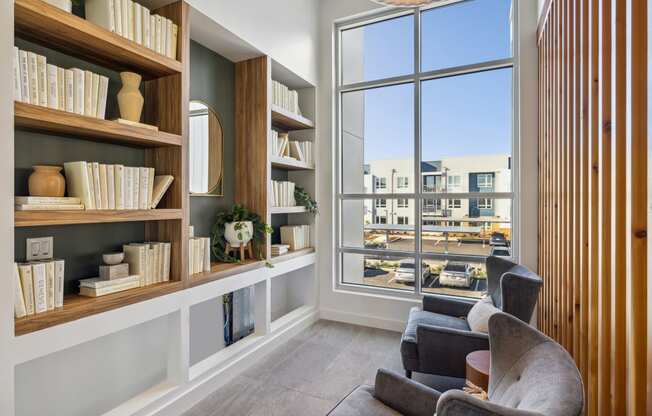 a living room with bookshelves and a large window