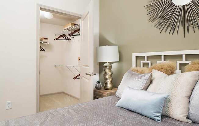 a bedroom with a bed and a closet with a lamp