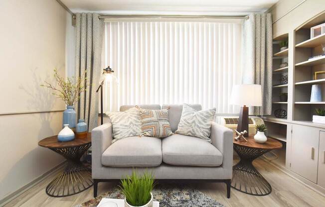 living room with large window, wood-style flooring, and built-in shelving