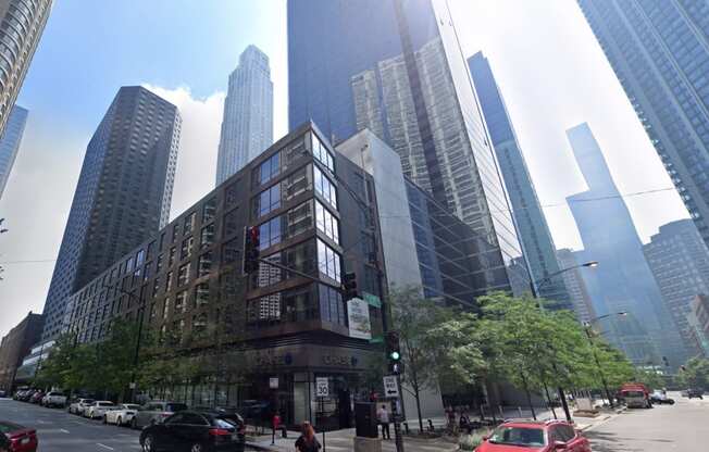 a building in front of tall buildings on a city street
