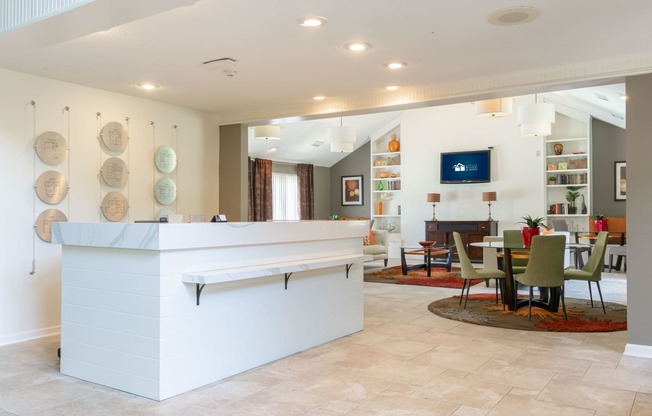 a living room with a bar and a dining room