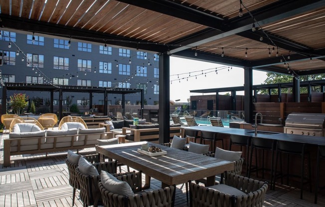 a patio with tables and chairs on a roof