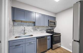 A kitchen with blue cabinets at Dunwoody Glen, Georgia ,30360