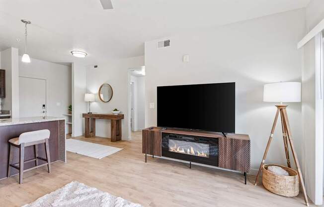 A modern living room with a flat screen TV and a fireplace.