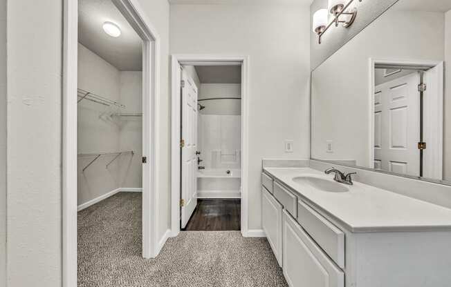 an empty bathroom with a sink and a mirror