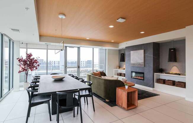 A modern dining room with a wooden table and chairs.