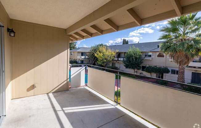 the condo has a large patio with a palm tree