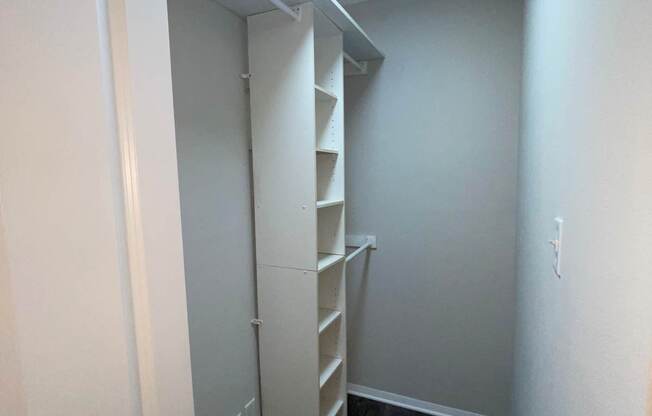 A small room with a white door and a staircase.