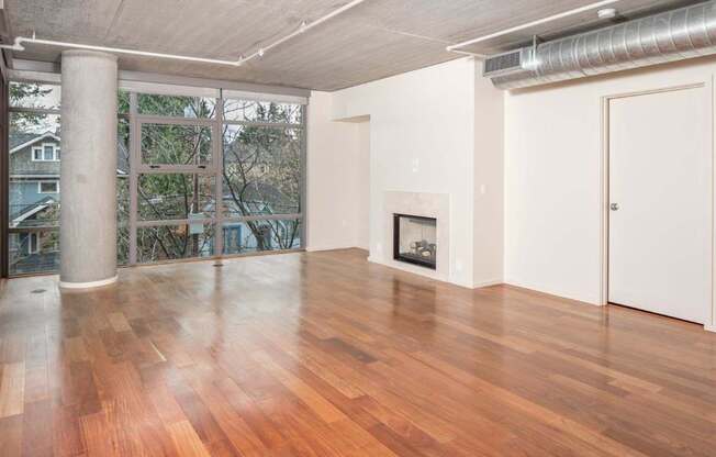 A room with wooden floors and a fireplace.