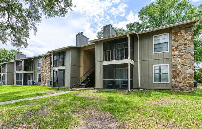 A row of houses with a green lawn in front.