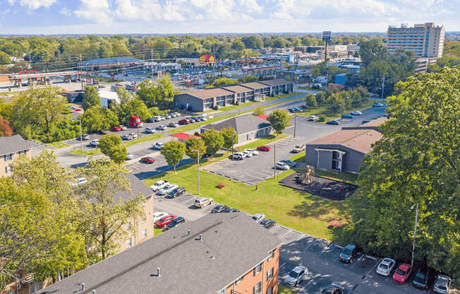 A parking lot with cars and a building in the background.