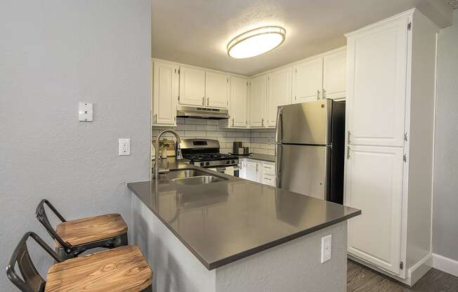 Kitchen with bar seating l Vue at the Lake in Sacramento