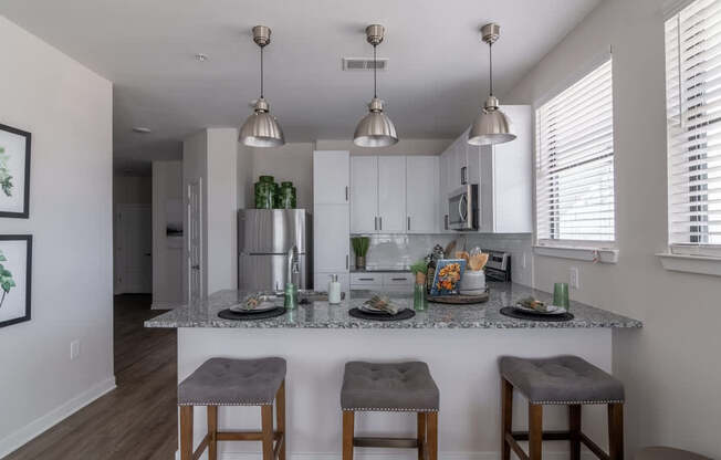 a kitchen with a marble counter top with three stools